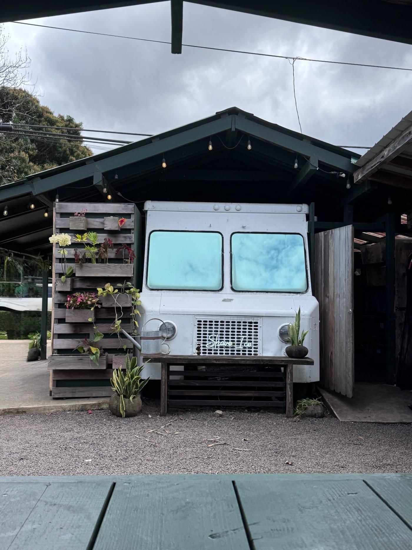 A vintage white food truck under a wooden pavilion near Princeville, Kauai
