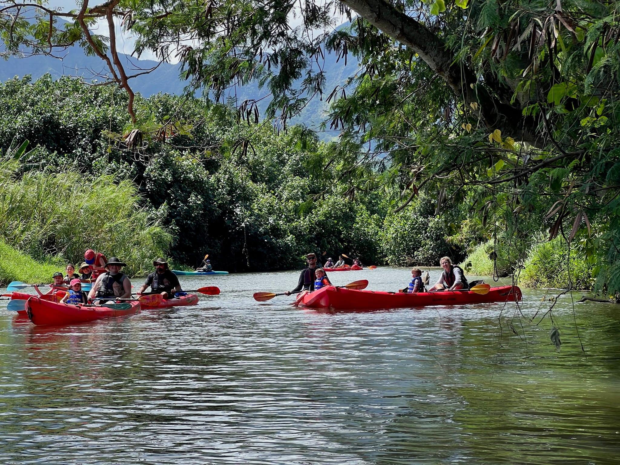 Group kayaking on the Hanalei River near Princeville, one of the best family activities on Kauai's North Shore