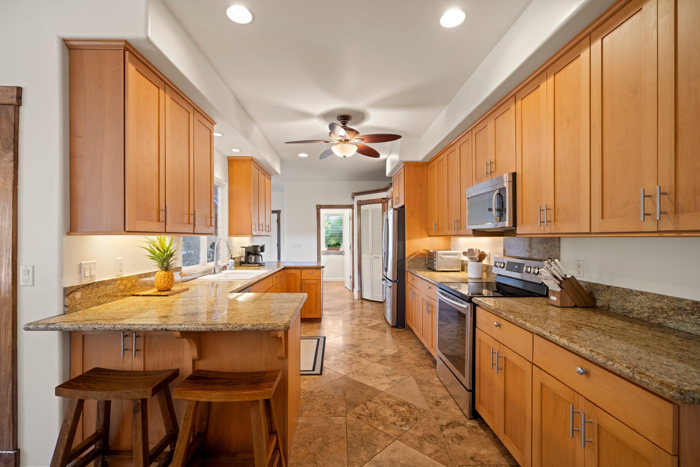 Open kitchen and dining area at Emmalani Hale in Princeville, Kauai