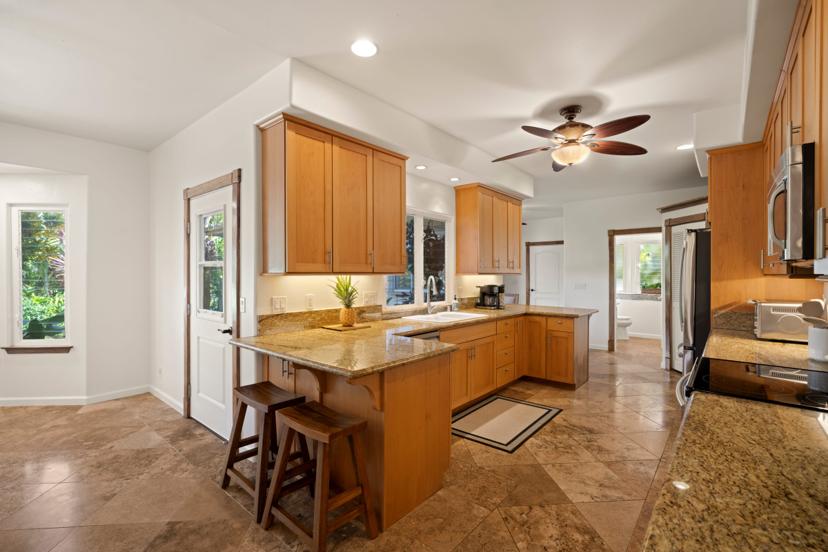 Open kitchen with peninsula seating at Princeville Kauai vacation rental