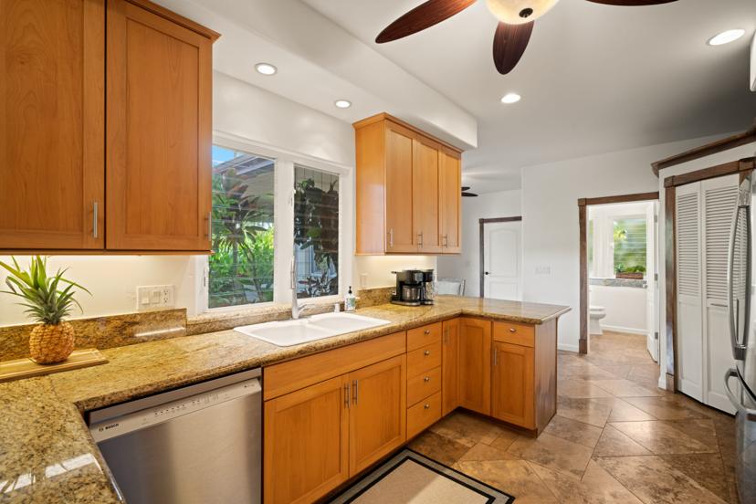 Kitchen with farmhouse window over sink at luxury Kauai rental