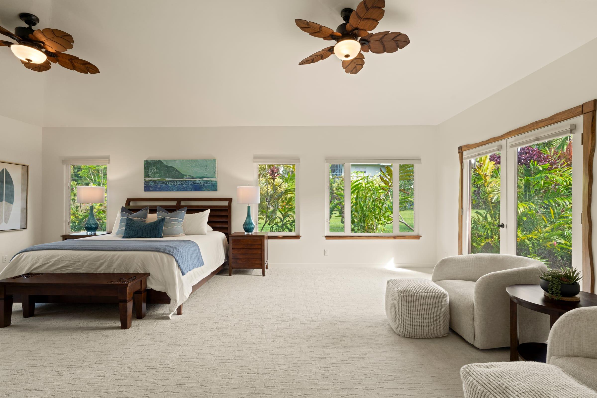 Spacious master bedroom with a king bed and central AC at Emmalani Hale, a Princeville rental with air conditioning