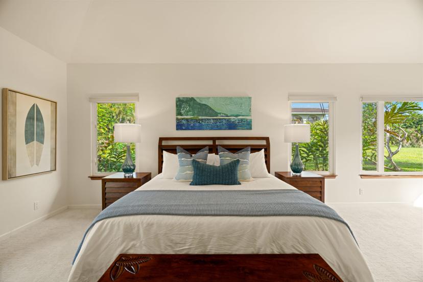 King bedroom with picture windows at luxury Princeville vacation rental
