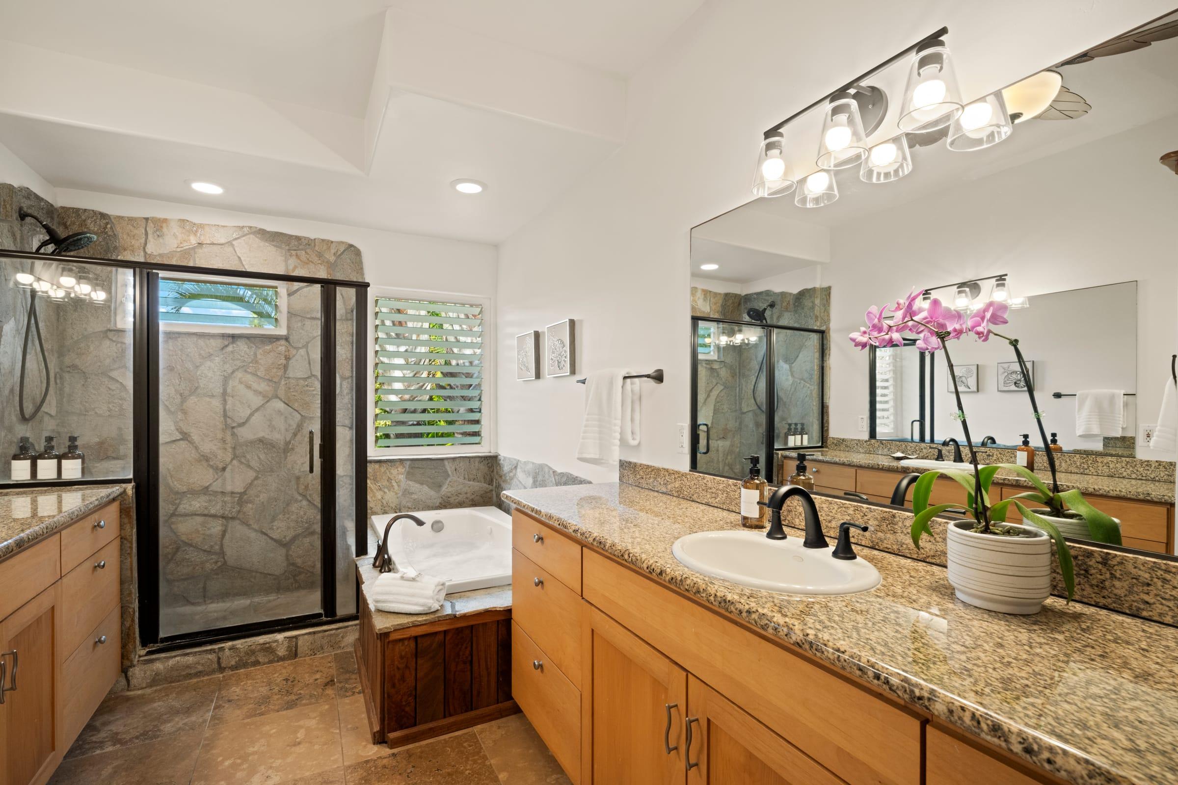 Master bathroom with a dual vanity, soaking tub, and walk-in shower at Emmalani Hale, Princeville Kauai