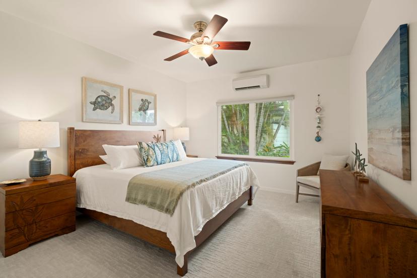 Guest bedroom with sea turtle art and AC at Princeville Kauai rental