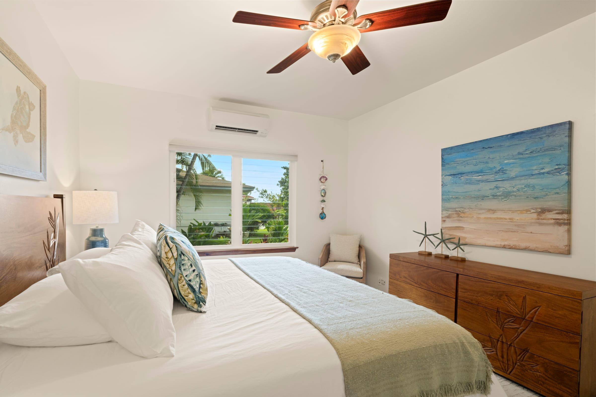 Guest bedroom with a ceiling fan and central AC at Emmalani Hale in Princeville, Kauai