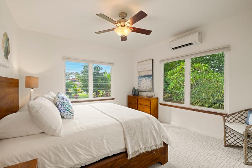 Bedroom with garden-view windows and AC, Princeville vacation rental