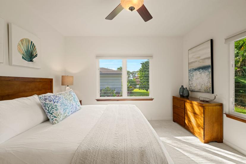 Guest bedroom with seashell artwork and dresser, Emmalani Hale Kauai