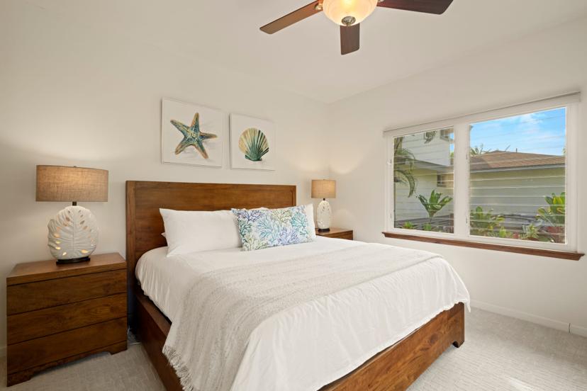 Guest bedroom with king bed, starfish and seashell art, Princeville rental