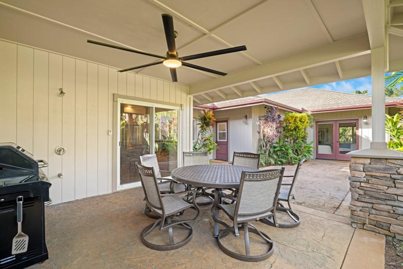 Furnished covered patio with dining table and ceiling fan at Hale