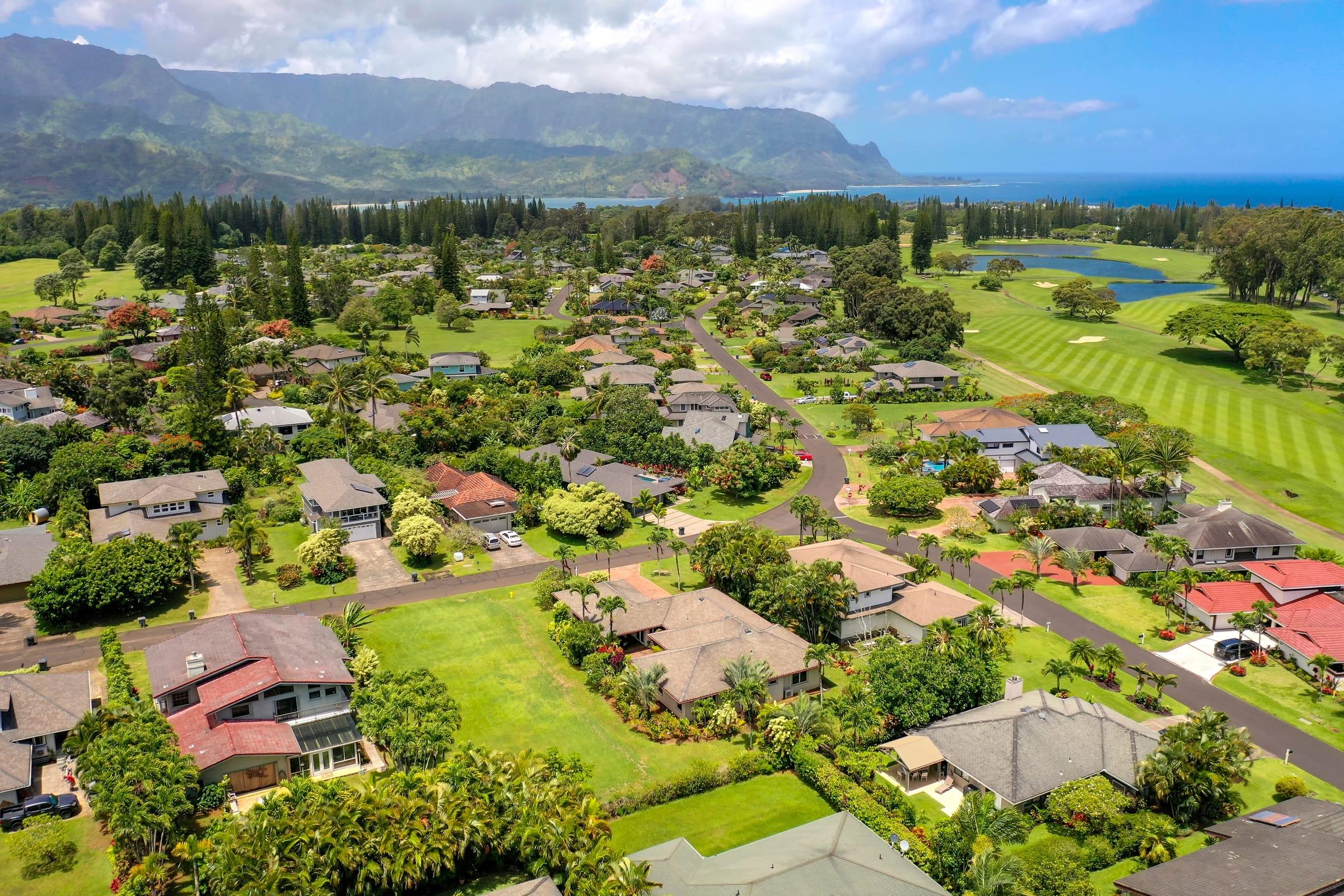 Aerial view of Emmalani Hale in Princeville with Hanalei Bay and mountains in the distance