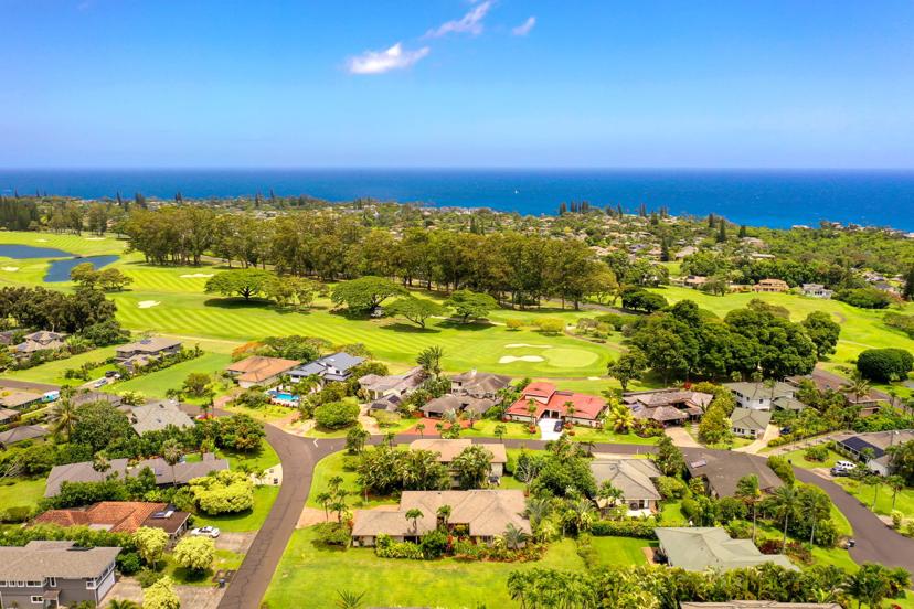 Aerial of Princeville golf course and homes with ocean horizon, Kauai