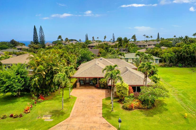 Drone aerial of Emmalani Hale property with Princeville ocean horizon