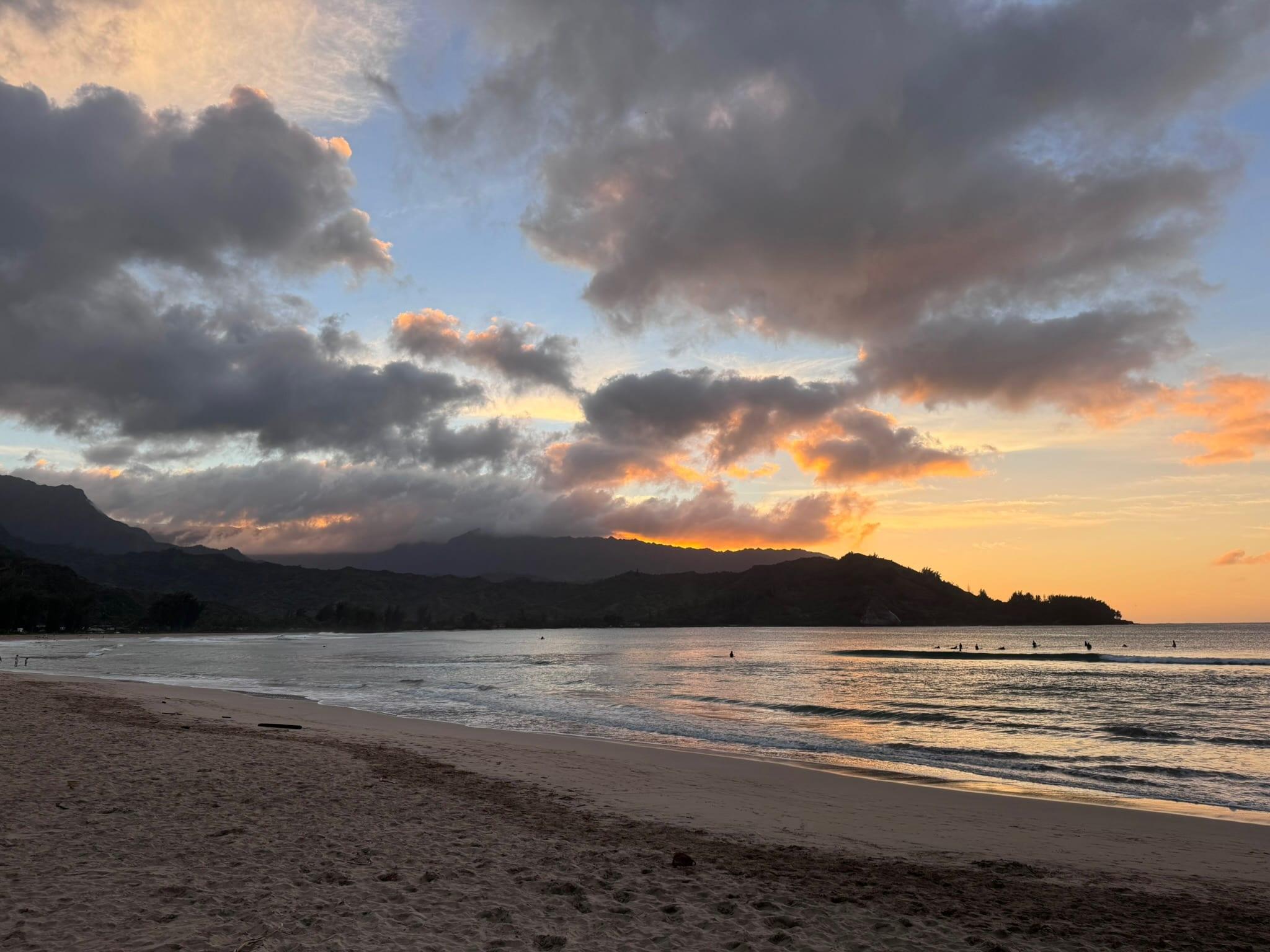 Hanalei Bay at sunset with the mountains in silhouette, 10 minutes from the Princeville rentals