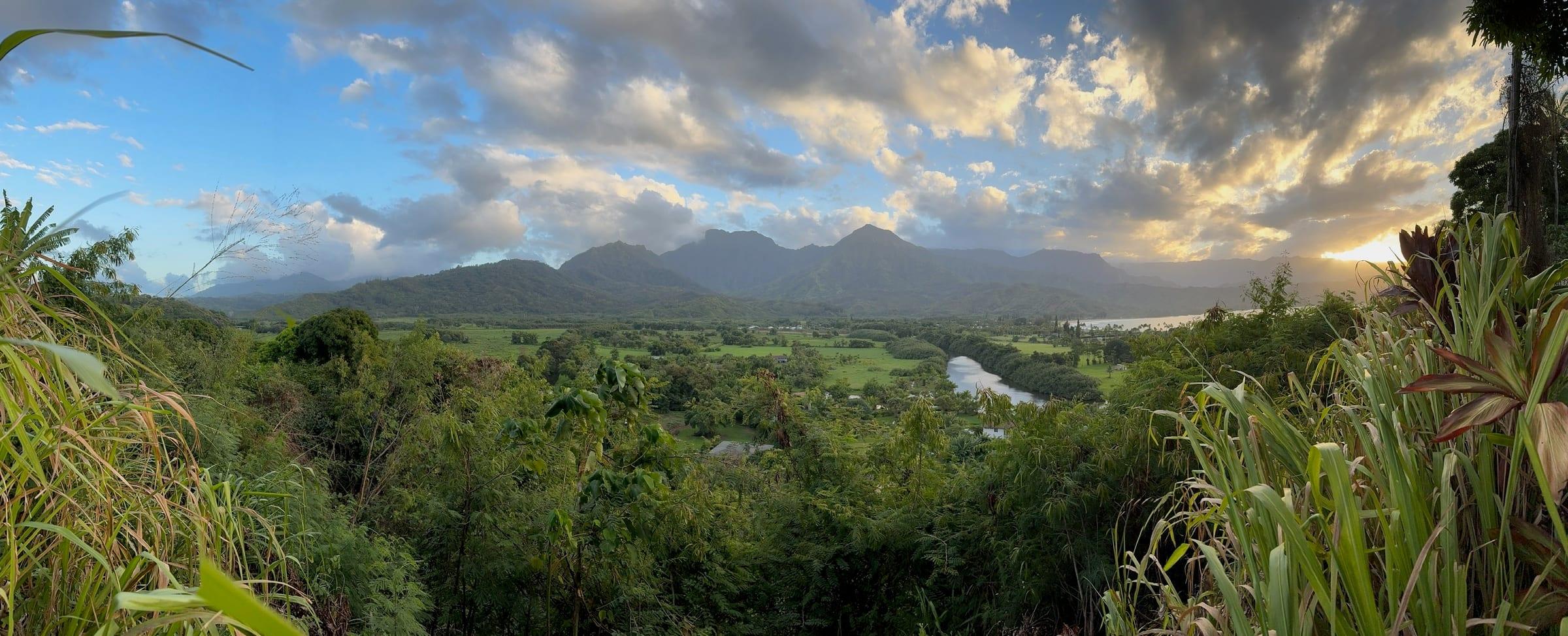 Hanalei Valley Lookout at golden hour: taro fields, river, and green mountains near Princeville, Kauai