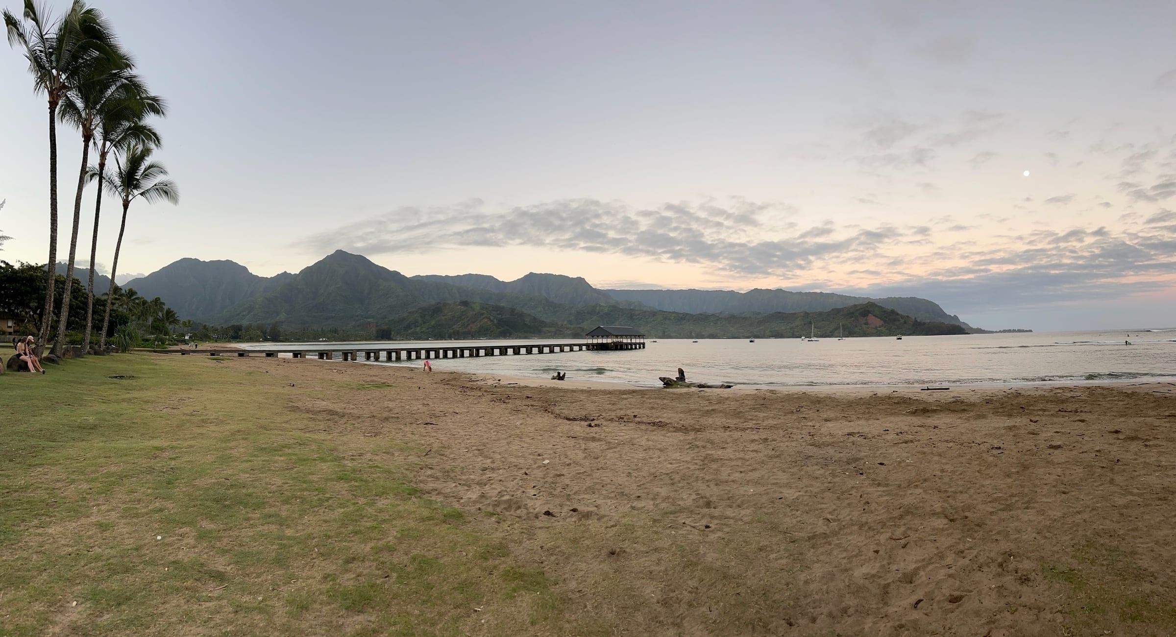 Hanalei Bay and pier at dusk near Princeville, Kauai, a romantic North Shore setting